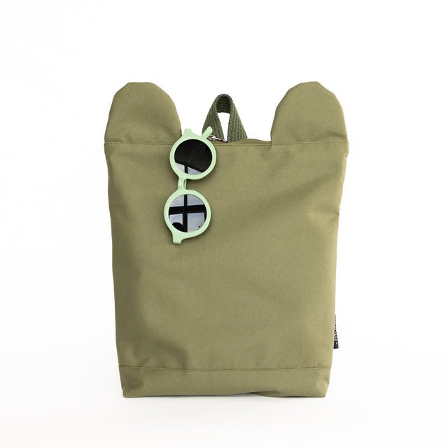 6. Muni Green Bear Backpack in studio with green sunglasses, showcasing playful accessory