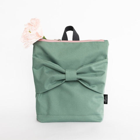 3. Studio image of Muni kids waterproof mint bow backpack with pink zipper and floral accent