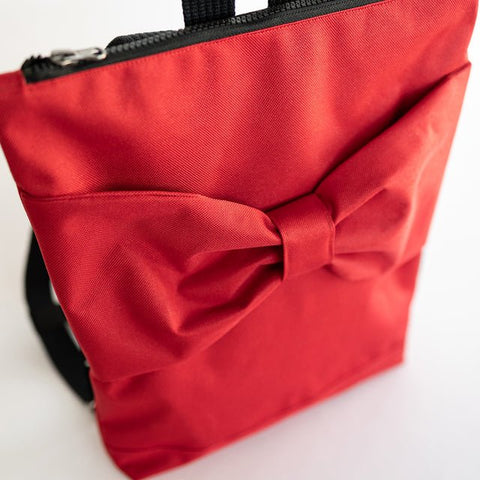 4. Close-up of Muni red bow kids backpack showing bow detail