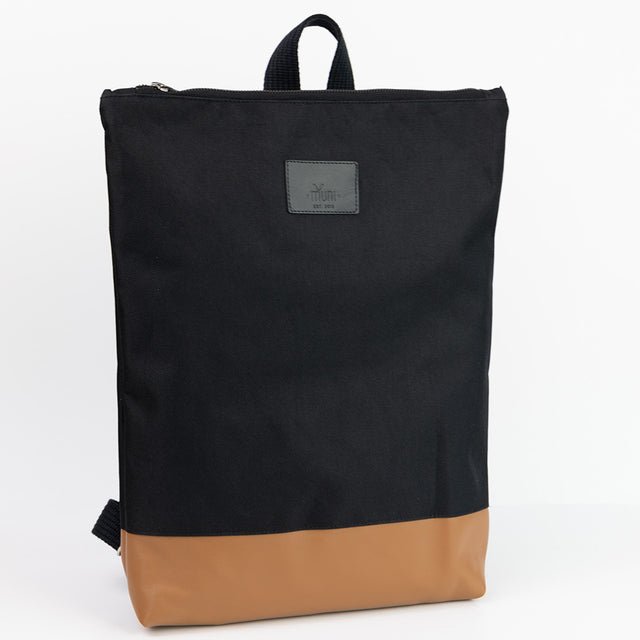 5. Front view of Muni waterproof backpack with tan leather bottom, highlighting brand logo in studio setting