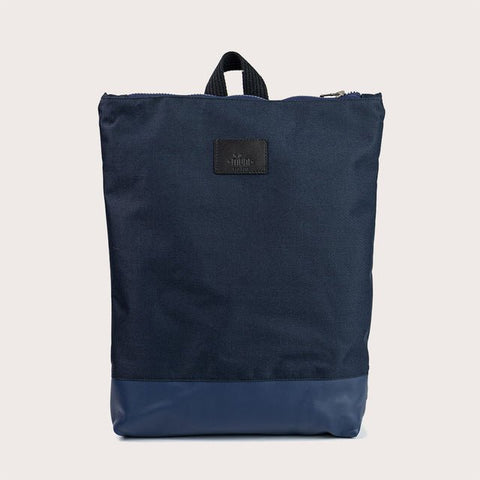 4. Muni waterproof backpack with blue leather bottom, shown in studio setting