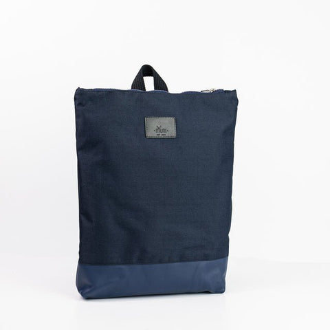 2. Studio shot of Muni waterproof backpack with blue leather bottom, showing front design