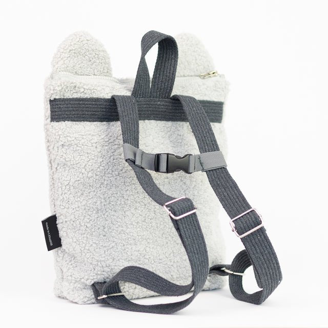 6. Back view of Muni grey teddy backpack in studio, showing adjustable straps and chest strap for secure fit