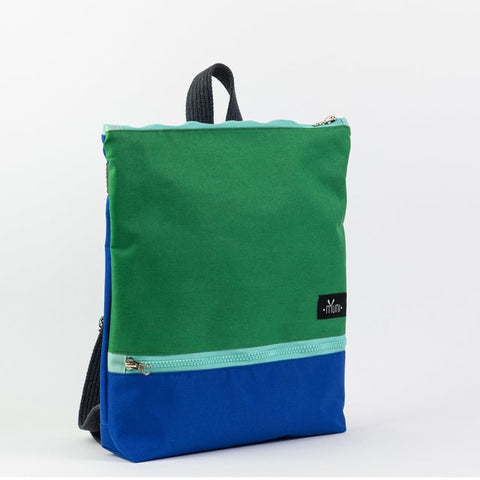 3. Studio shot of Muni waterproof kids backpack in green and blue, front view with logo