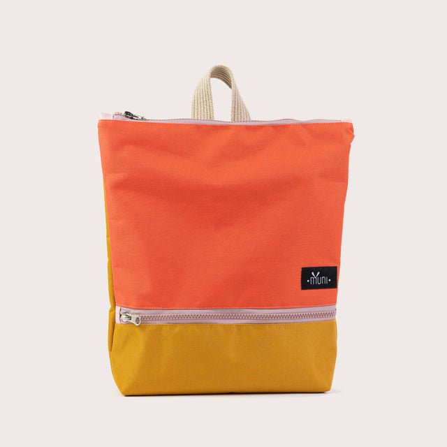 6. Studio image of Muni kids backpack in orange and yellow, highlighting front design and brand logo