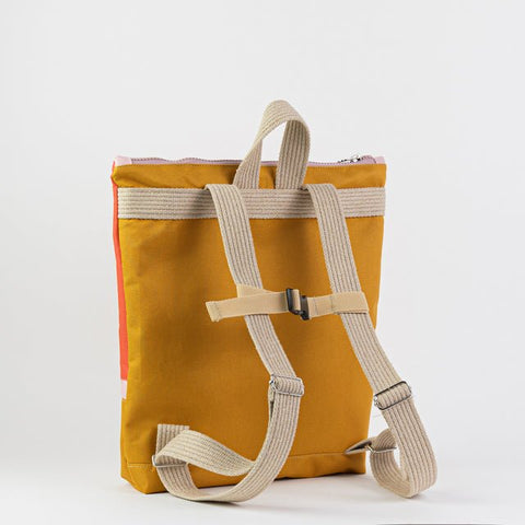 3. Back view of Muni kids backpack in yellow, showing adjustable shoulder and chest straps