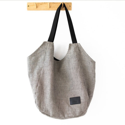 5. Muni striped linen tote bag hanging on a wooden hook
