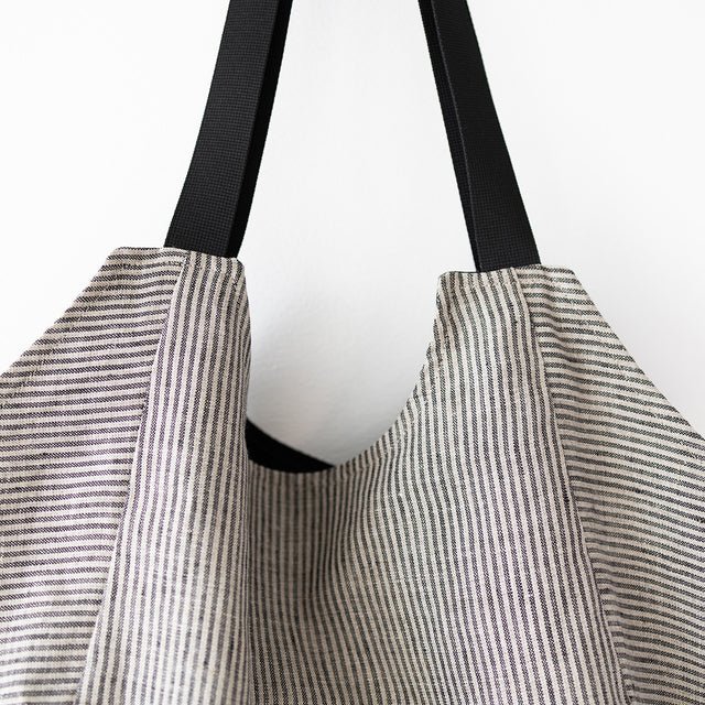 10. Close-up of black handles on Muni striped linen tote bag
