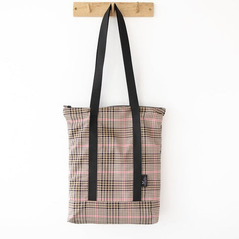5. Studio shot of Muni tartan tote bag hanging, highlighting spacious design and black straps