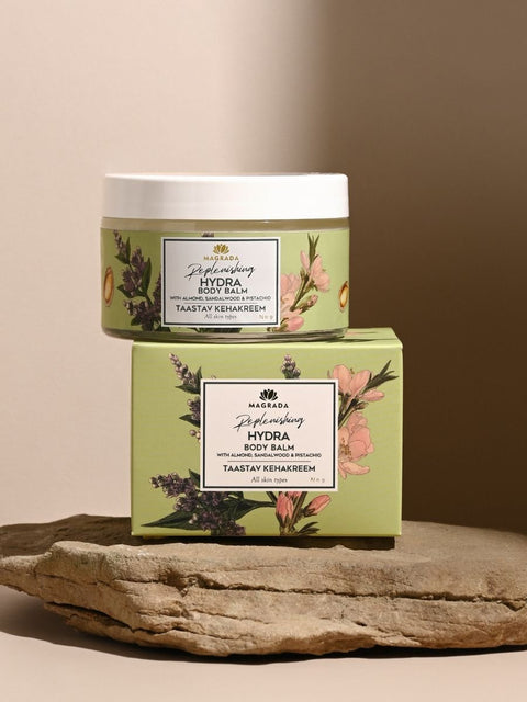 4. Magrada X Lauren Replenishing Body Balm jar and box with floral design on stone surface