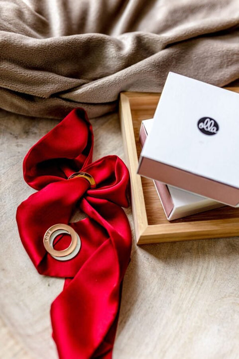 4. Red silk ribbon bracelet with gold LOVE ring, styled with Olla packaging