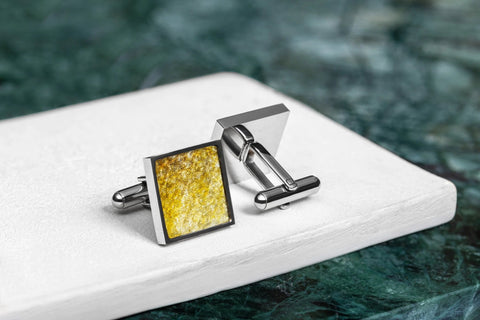 3. Close-up of Eherüs yellow leather square cufflinks on white surface, highlighting unique fish scale pattern