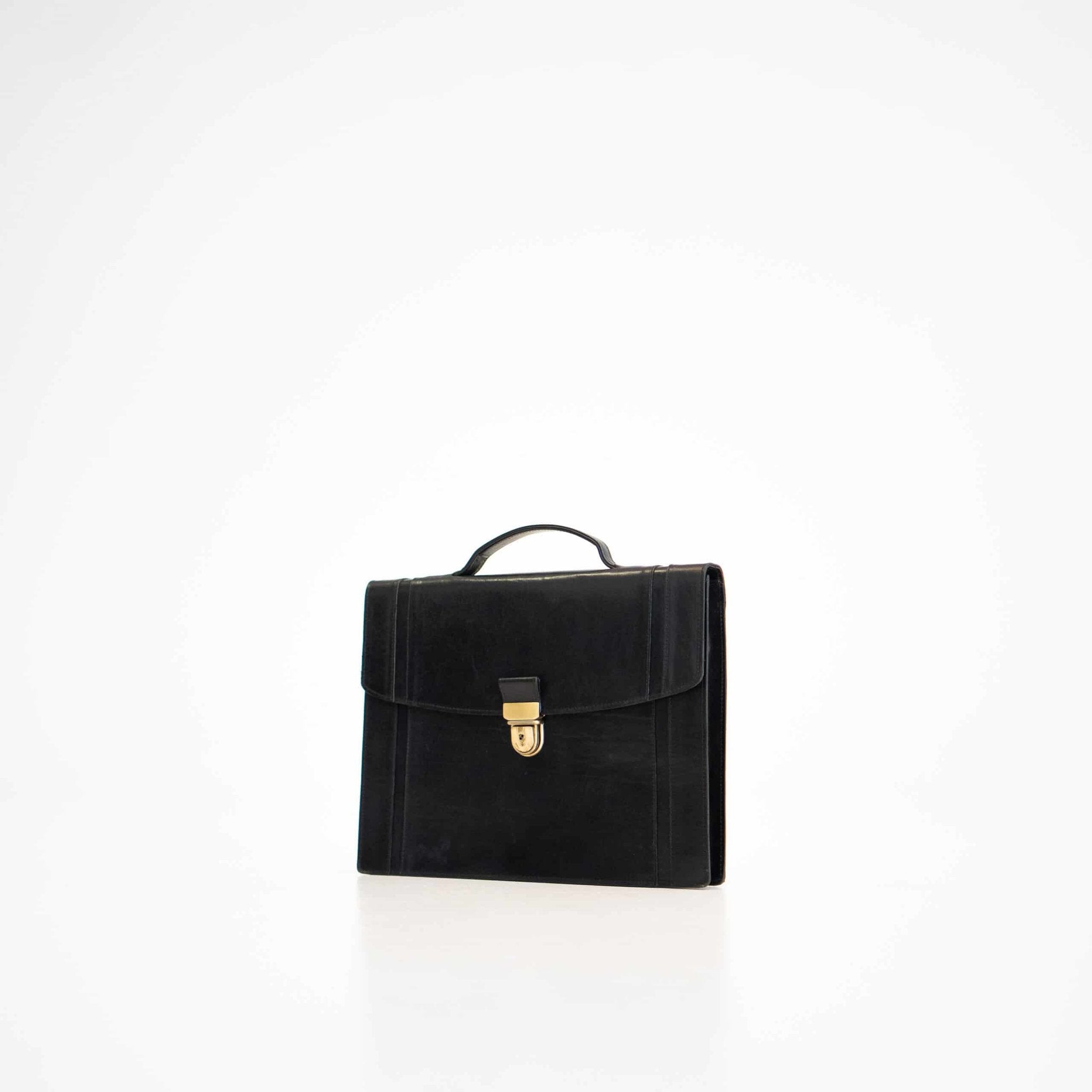 1. Papillon Briefcase No. 21 in black leather, front view with gold clasp, studio setting