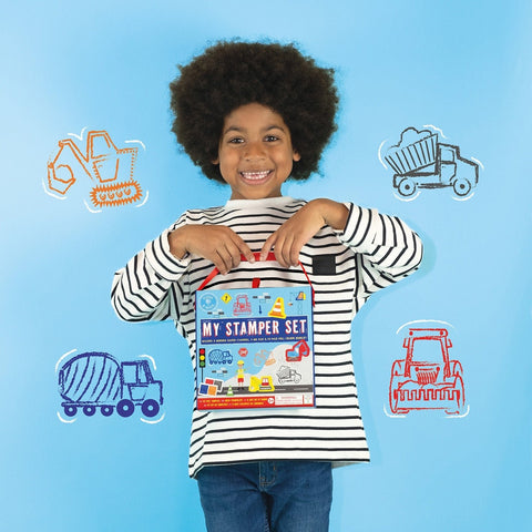 1. Child holding My Stampler Set against blue background with construction vehicle illustrations