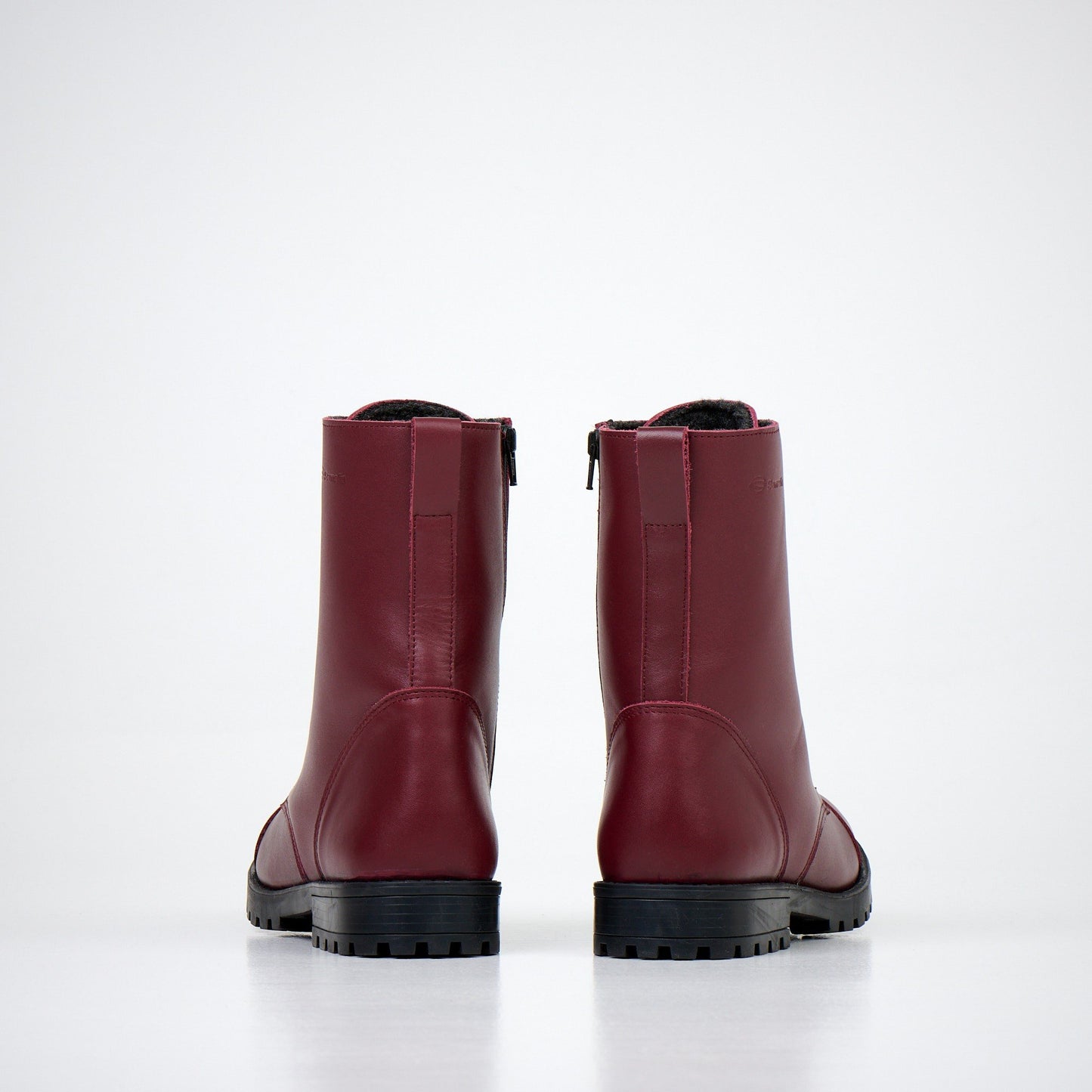 2. Back view of unisex burgundy winter boots by Samelin, highlighting zipper and fur lining