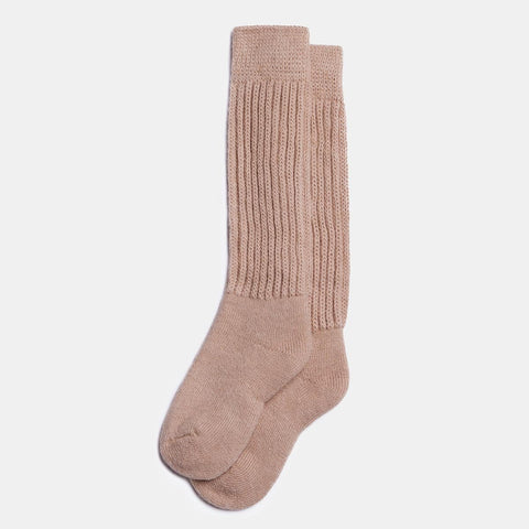 1. Unisex long alpaca wool socks in beige, featuring ribbed knit design, shown in studio setting