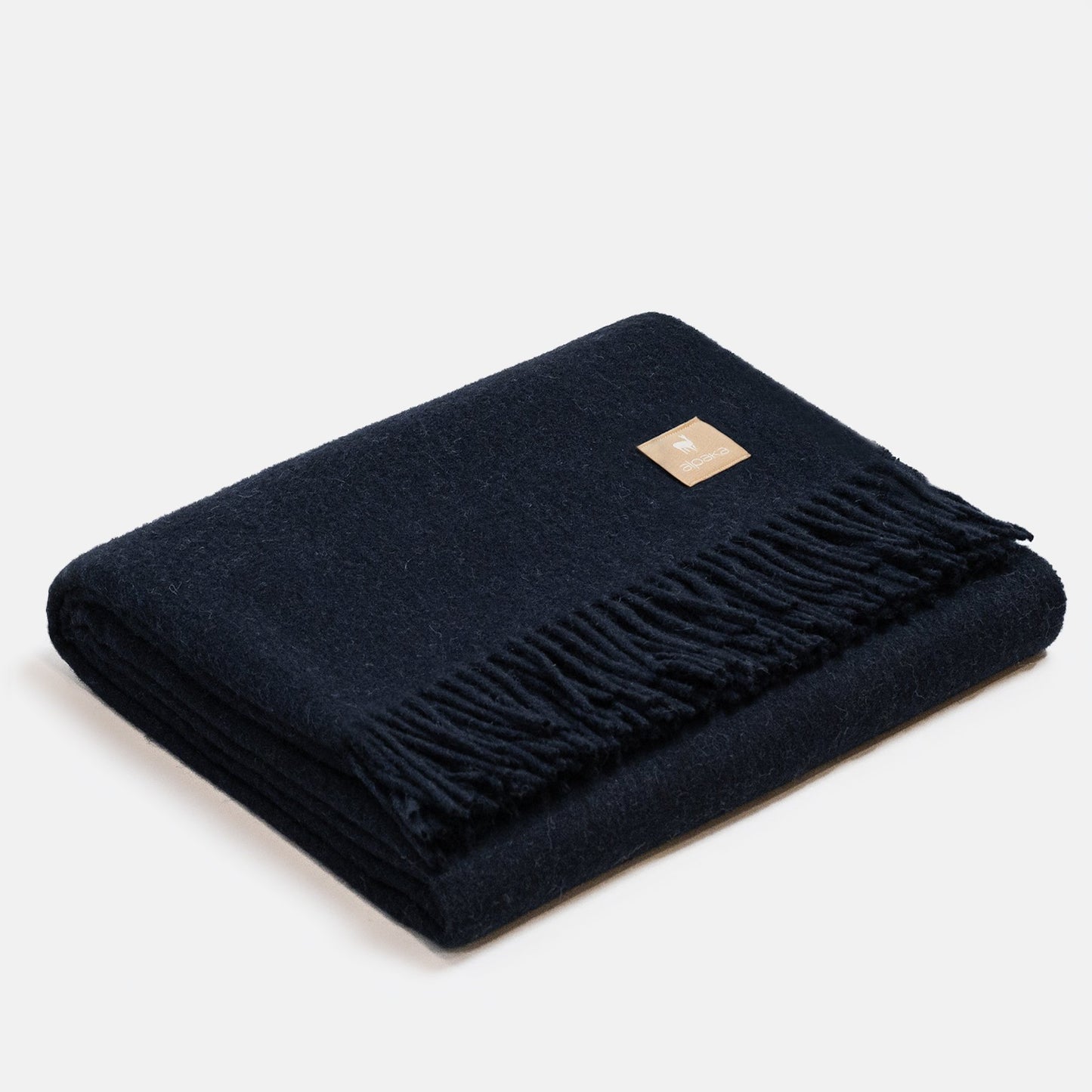 10. Dark red Alpaka natural alpaca wool throw with fringe detail, folded in studio