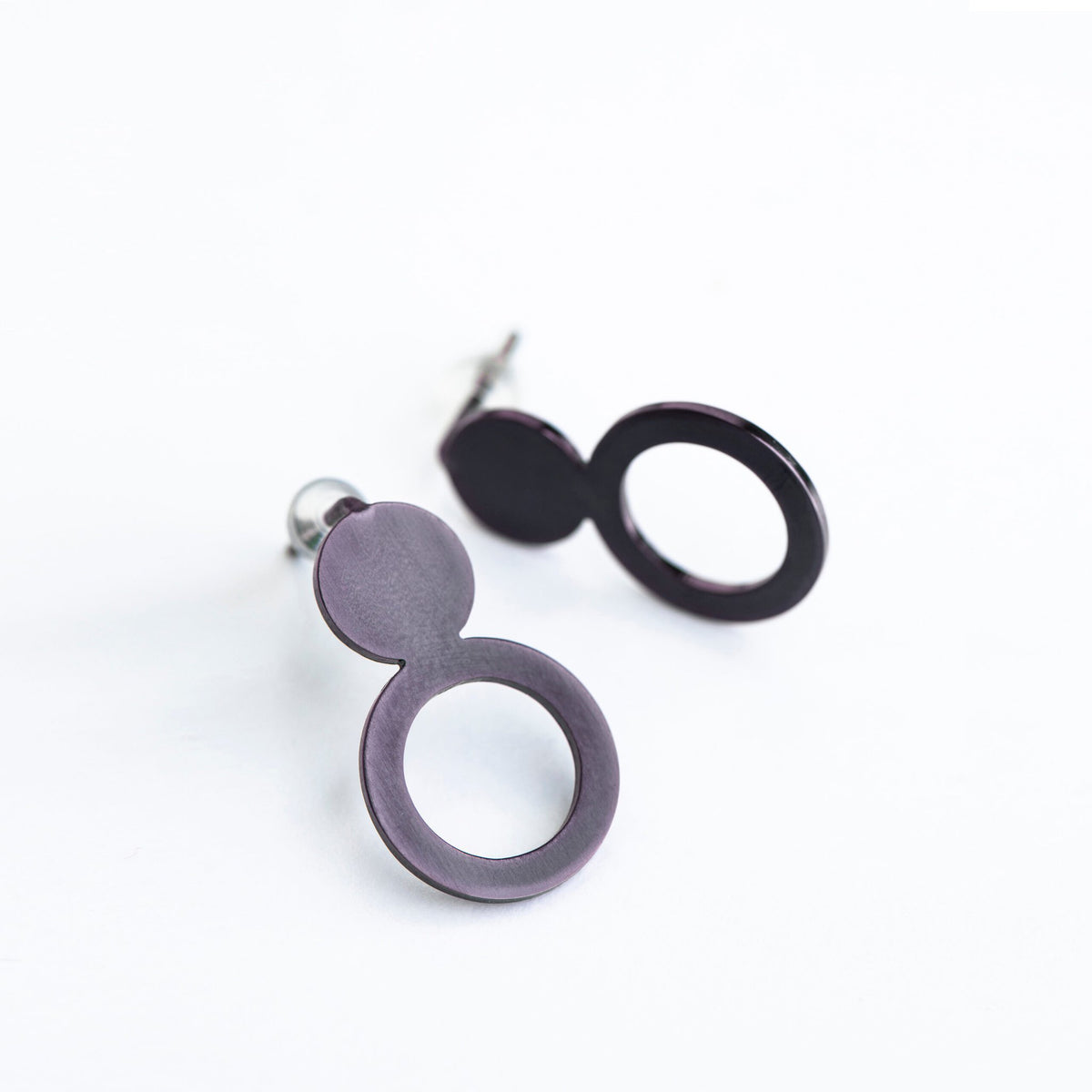 9. Studio shot of Lentsius Arc Purple earrings, highlighting upcycled industrial materials