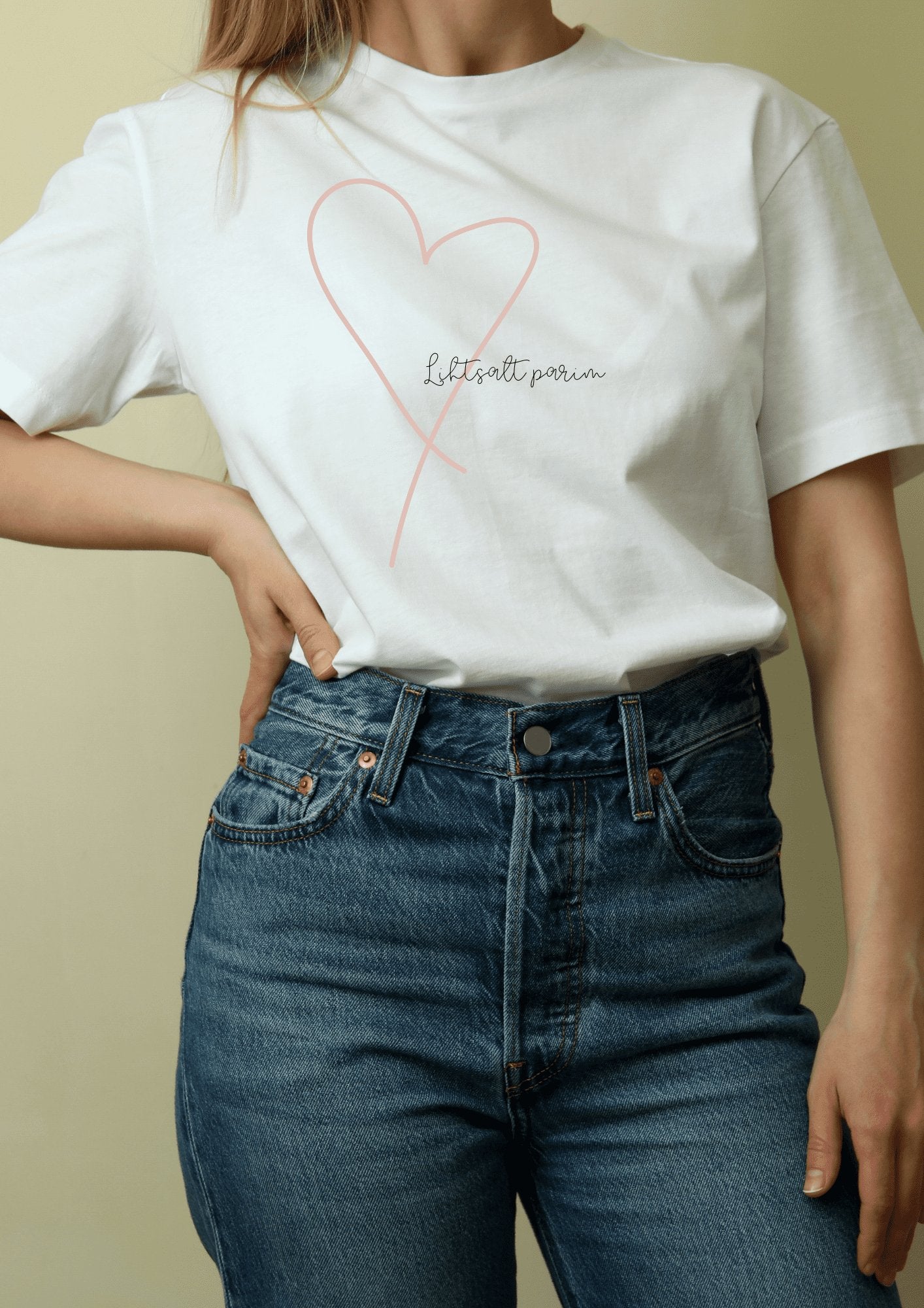 1. Women's white T-shirt with heart design and 'Lihtsalt parim' text, styled with jeans, by Black Giraffe Brand