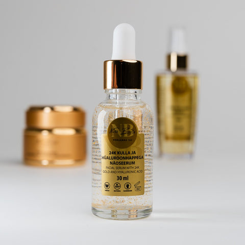 4. North Beauty 24K Gold facial serum bottle with rice oil and face cream in background, studio shot