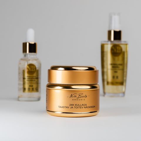 2. North Beauty 24K Gold face cream jar with facial serum and rice oil in background, studio shot
