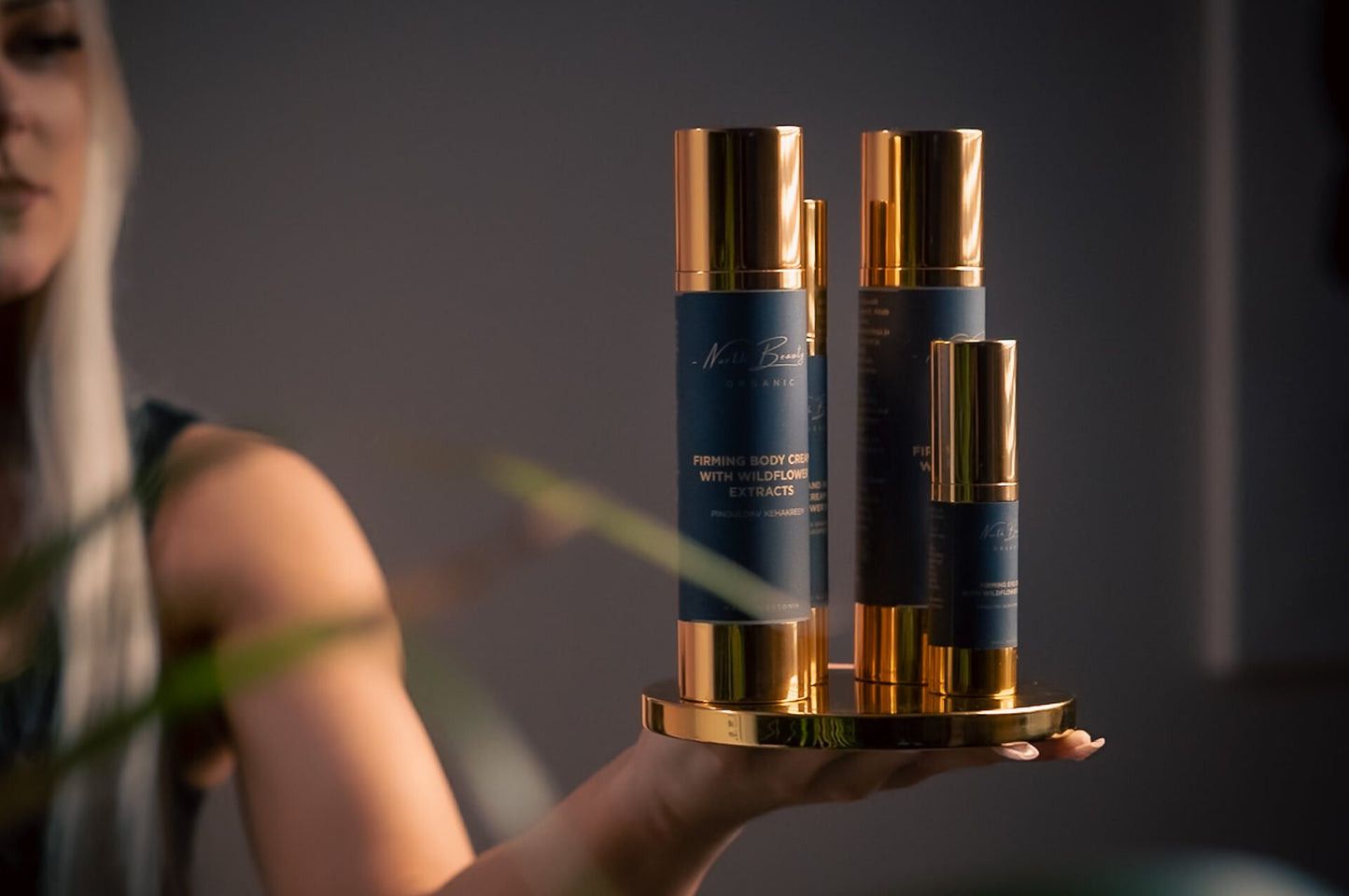 4. North Beauty firming eye cream and body products held by a woman, highlighting elegant design in a lifestyle setting