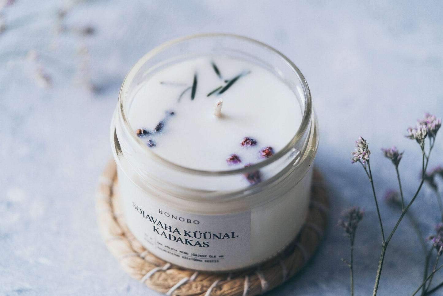 4. Close-up of BONOBO juniper scented candle with visible soy wax and essential oils, showing natural elements