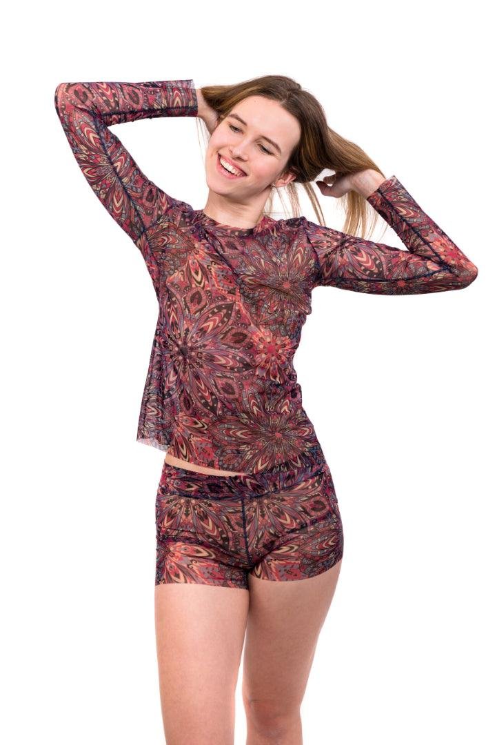 1. Women's tan-through mini leggings in terracotta mandala pattern, paired with matching long-sleeved blouse, shown in studio setting