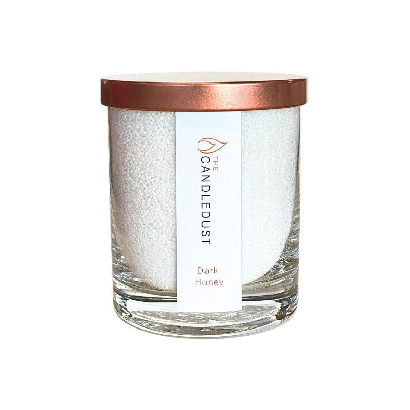 4. Studio image of Candledust Dark Honey powdered candle in a glass container with rose gold lid