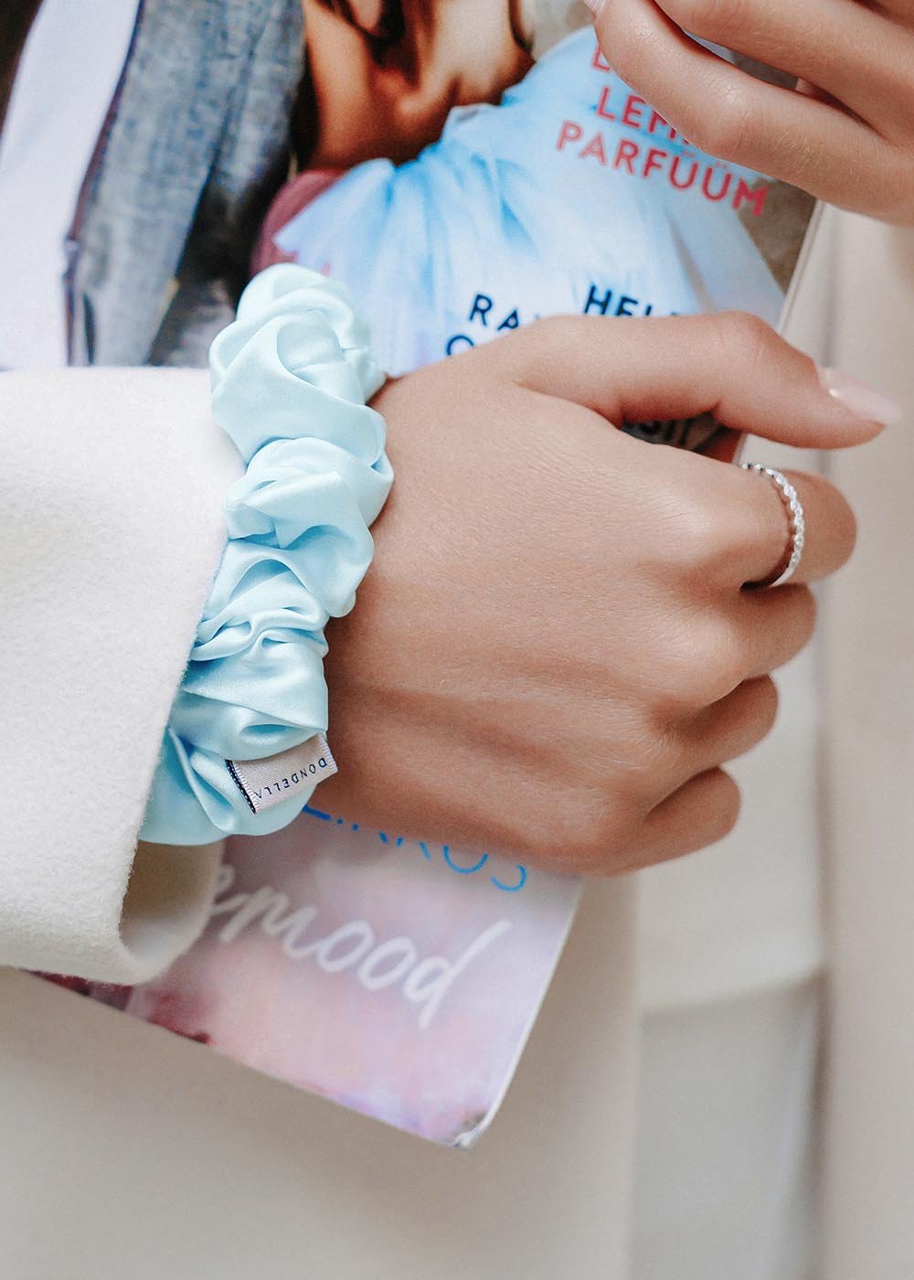 1. Woman wearing Dondella Aqua Mulberry Silk Scrunchie as a bracelet, showcasing elegant style