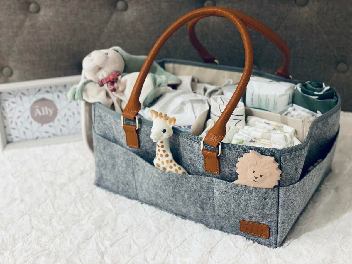 2. Close-up of Ally Scandic diaper caddy organizer filled with baby essentials, featuring felt and vegan leather