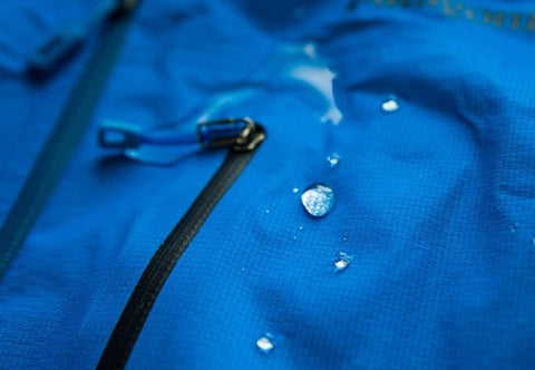 4. Close-up of blue fabric with water droplets, showcasing GoGoNano EcoProtect's waterproofing capabilities