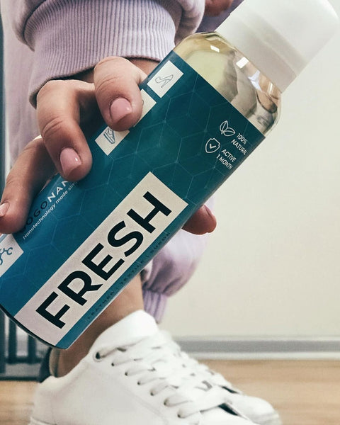 1. GoGoNano shoe freshener with probiotics held by a person in casual wear, highlighting eco-friendly and natural formula