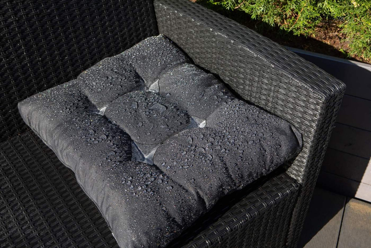 4. Black cushion with water droplets on outdoor chair, highlighting GoGoNano Stay Dry Nano Coating Spray water repellency