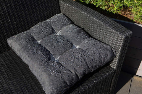 4. Black cushion with water droplets on outdoor chair, highlighting GoGoNano Stay Dry Nano Coating Spray water repellency