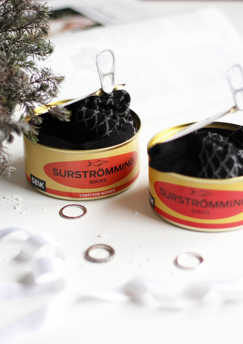 2. Close-up of SEIK Surstrƶmming socks in tin can, showcasing unique packaging and playful design for men