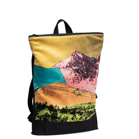 5. Side view of Muni Bold Mountains backpack with mountain design in studio