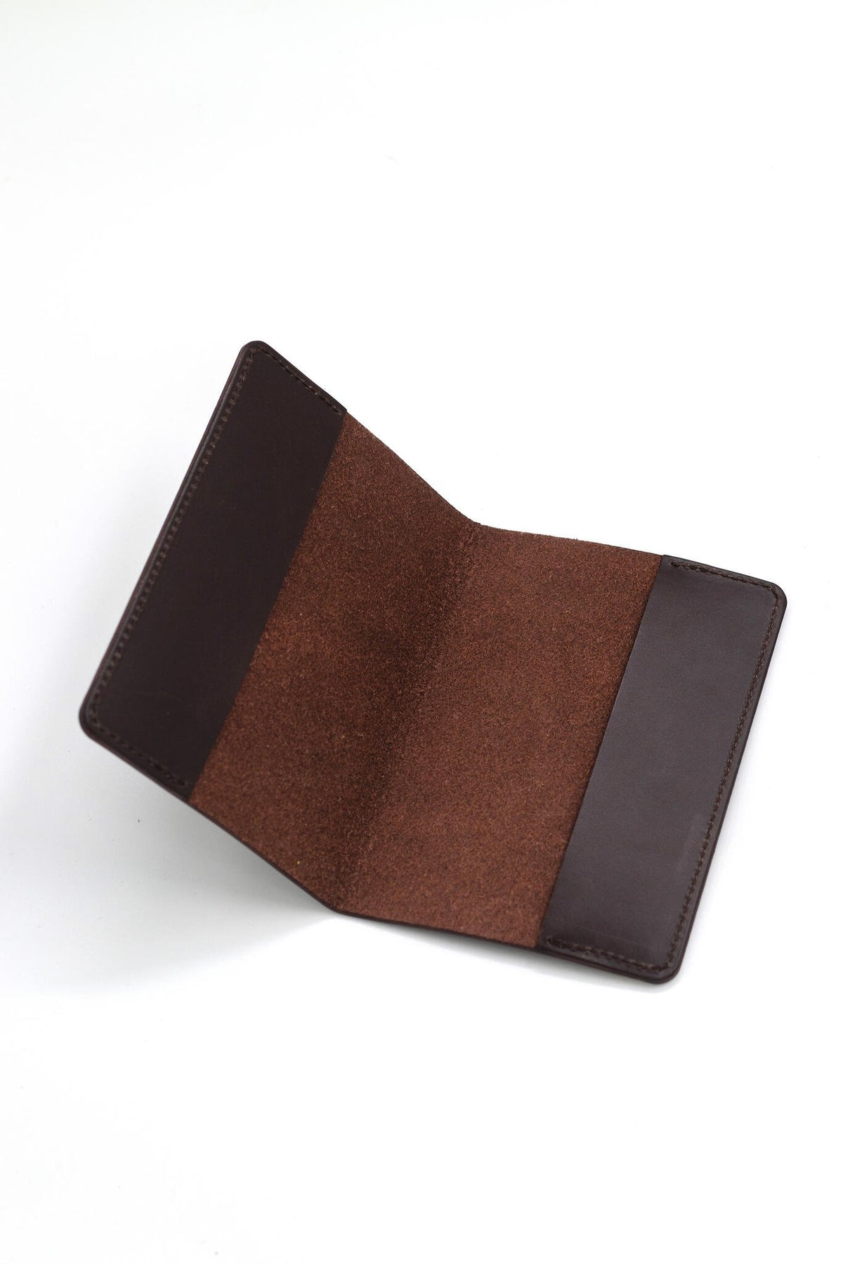 2. Interior view of dark brown leather passport cover by Stella Soomlais showing suede lining