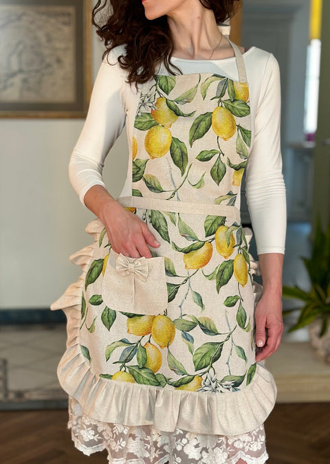 1. Women's apron with frills and pocket in lemon print by Hortensias Home, worn in a lifestyle setting