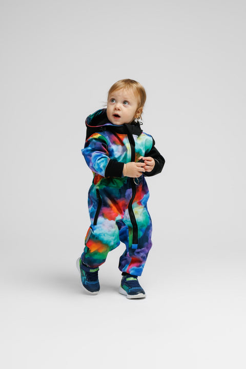 1. Toddler wearing colorful softshell onesie with black hood and cuffs, standing on white background