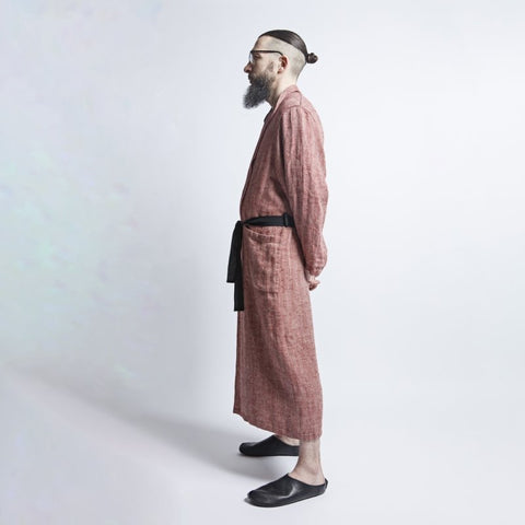 3. Profile of man in red fishbone pattern linen bathrobe with black belt, hands behind back