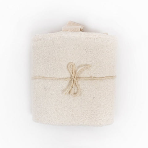 4. Rolled white linen towel with fishbone pattern tied with string, showing compact and portable design