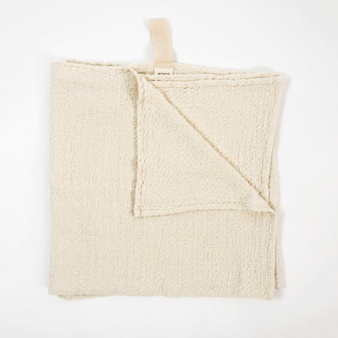 1. Flat lay of KOOSdisain big linen towel in textured white fabric with a visible cotton hanger