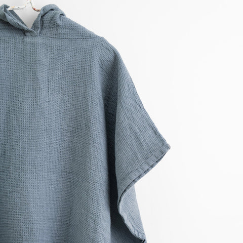 3. Close-up of kids' blue fog linen poncho showing fine waffle texture and hood detail