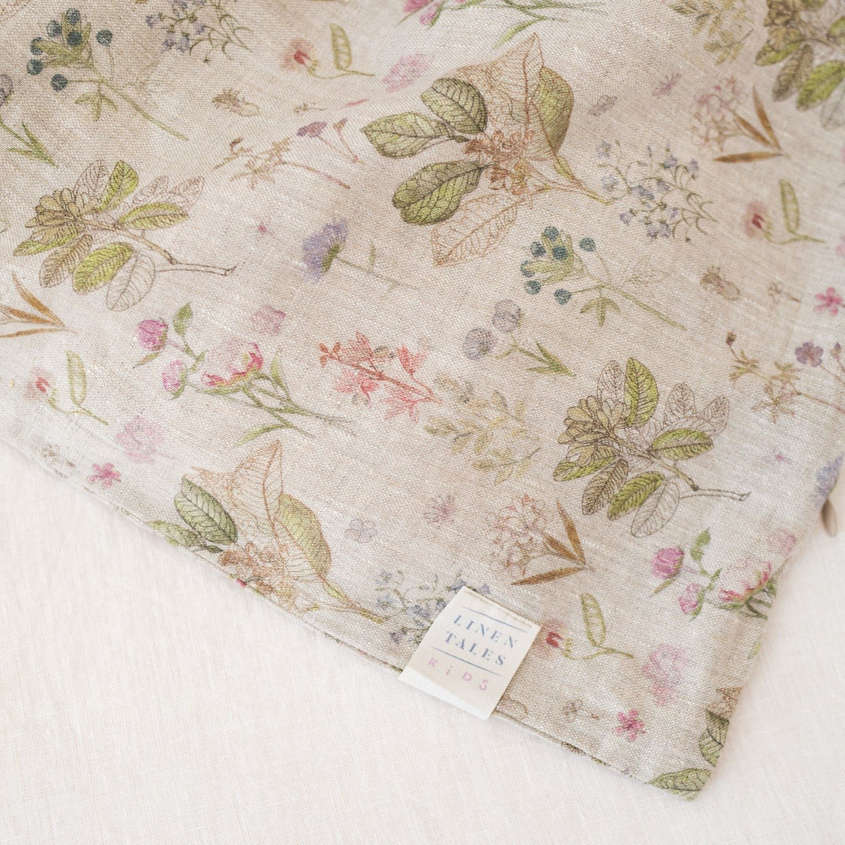 3. Close-up of Linen Tales label on botanical print linen fabric for kids' duvet cover