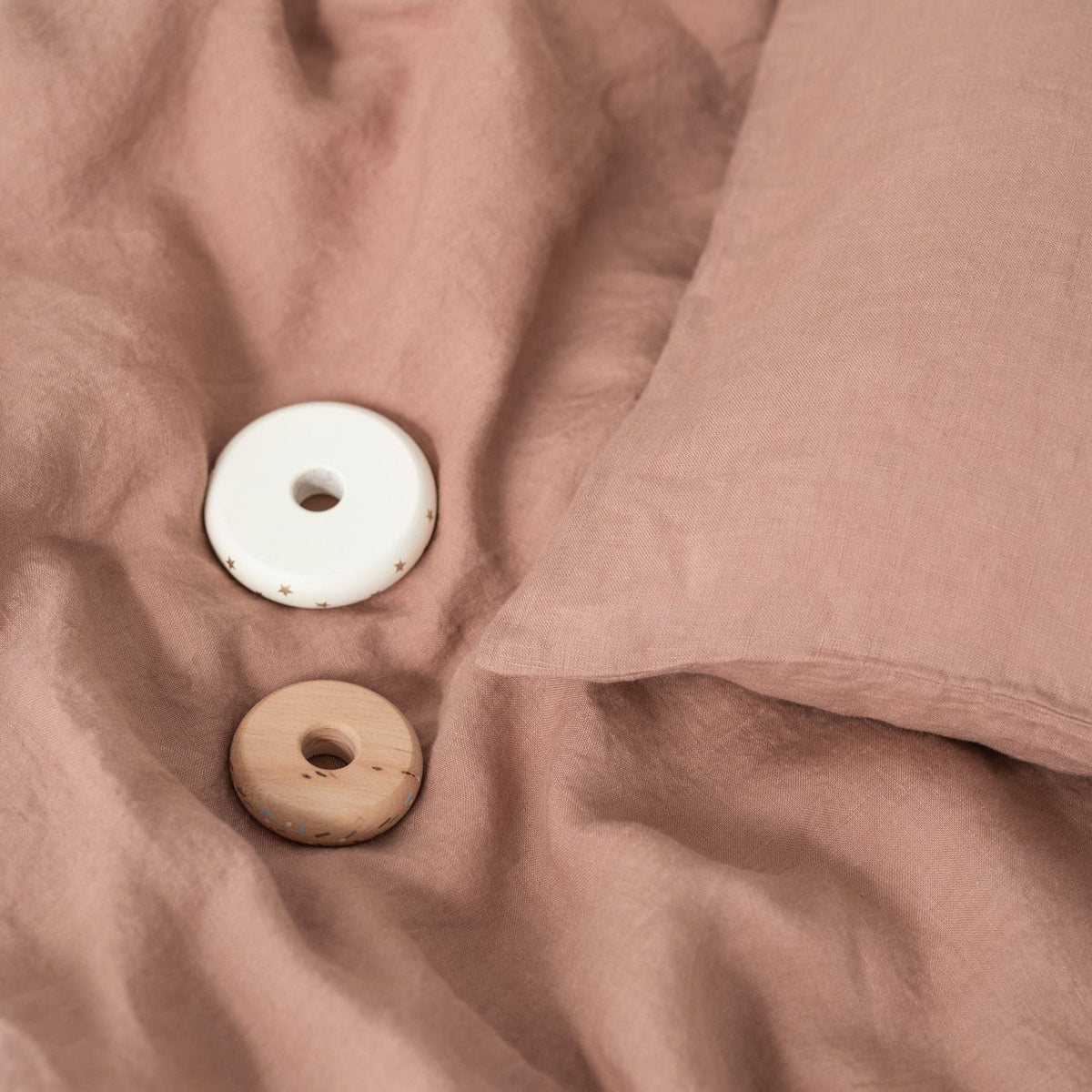 7. Cafe creme linen duvet cover with pillowcase and wooden toys on soft fabric