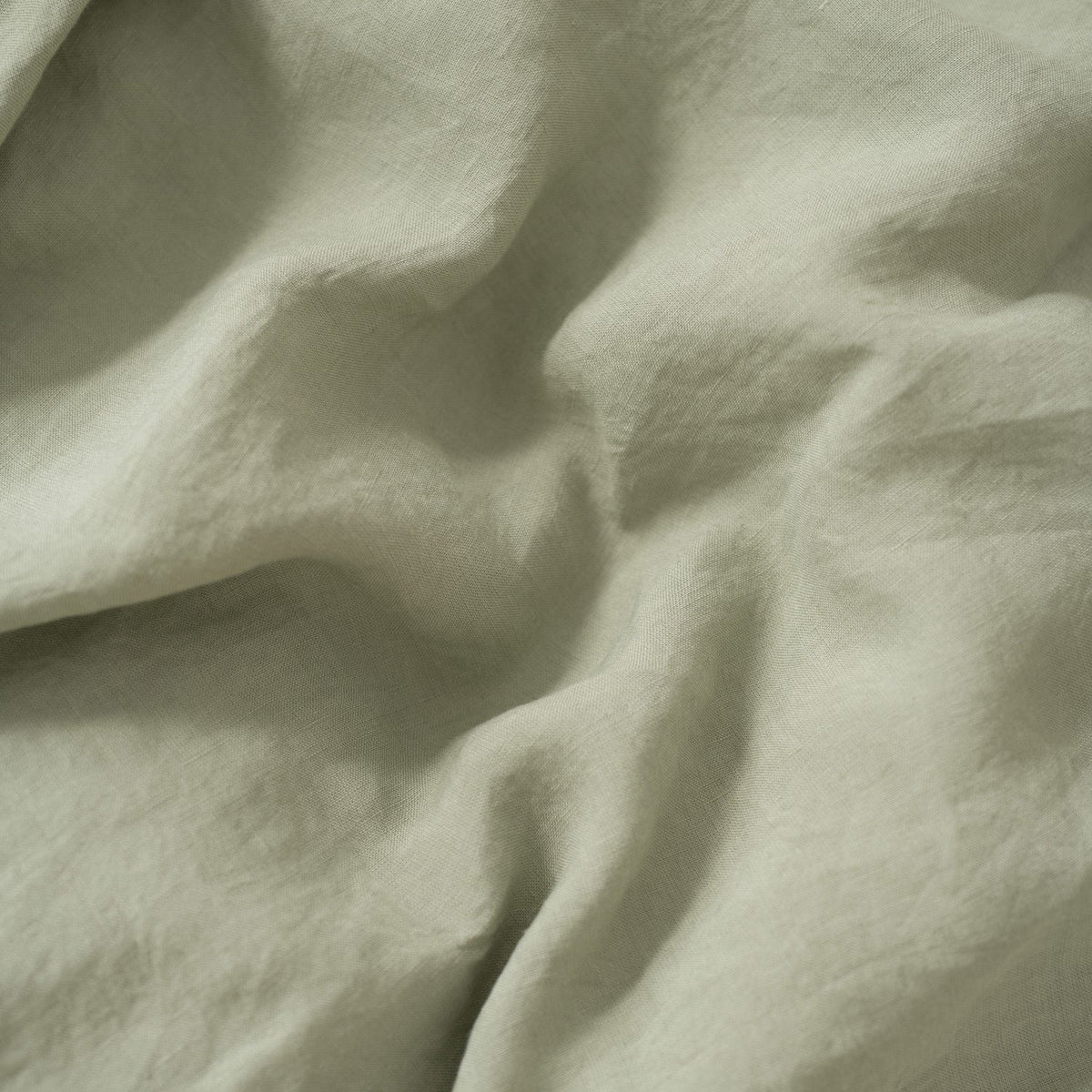 3. Close-up of sage green linen fabric showing texture and softness
