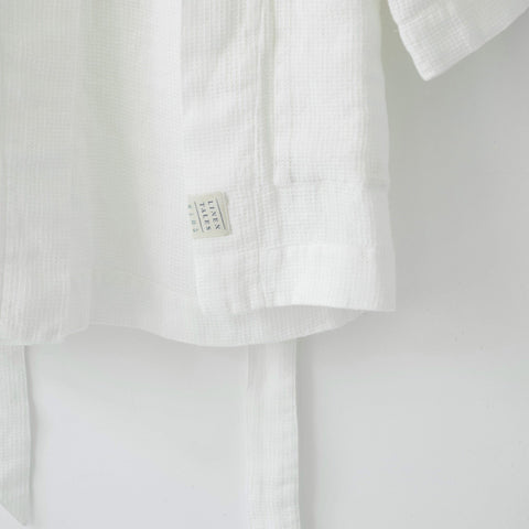 3. Close-up of white linen bathrobe showing Linen Tales label and waffle texture