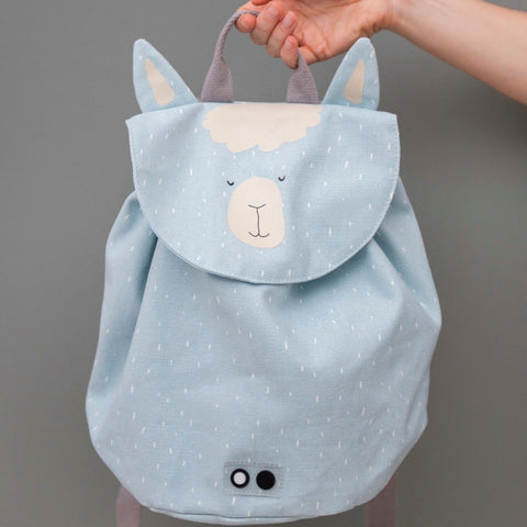 1. Person holding Trixie Baby Mr Alpaca Mini Drawstring Backpack in light blue with alpaca face design