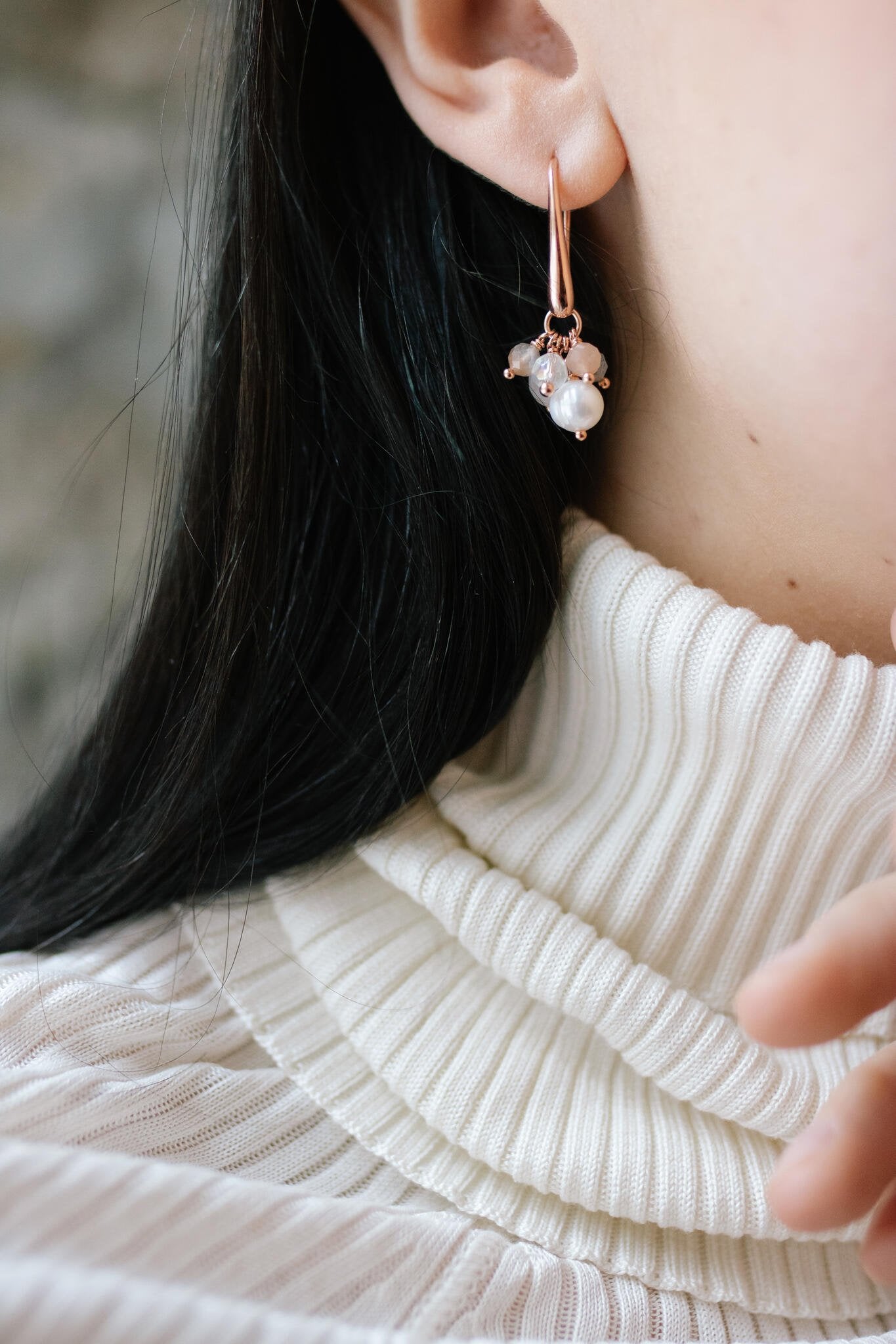 1. Women's Cherie Black Earrings in rose gold plating with black onyx and red garnet gems, worn by model in lifestyle setting
